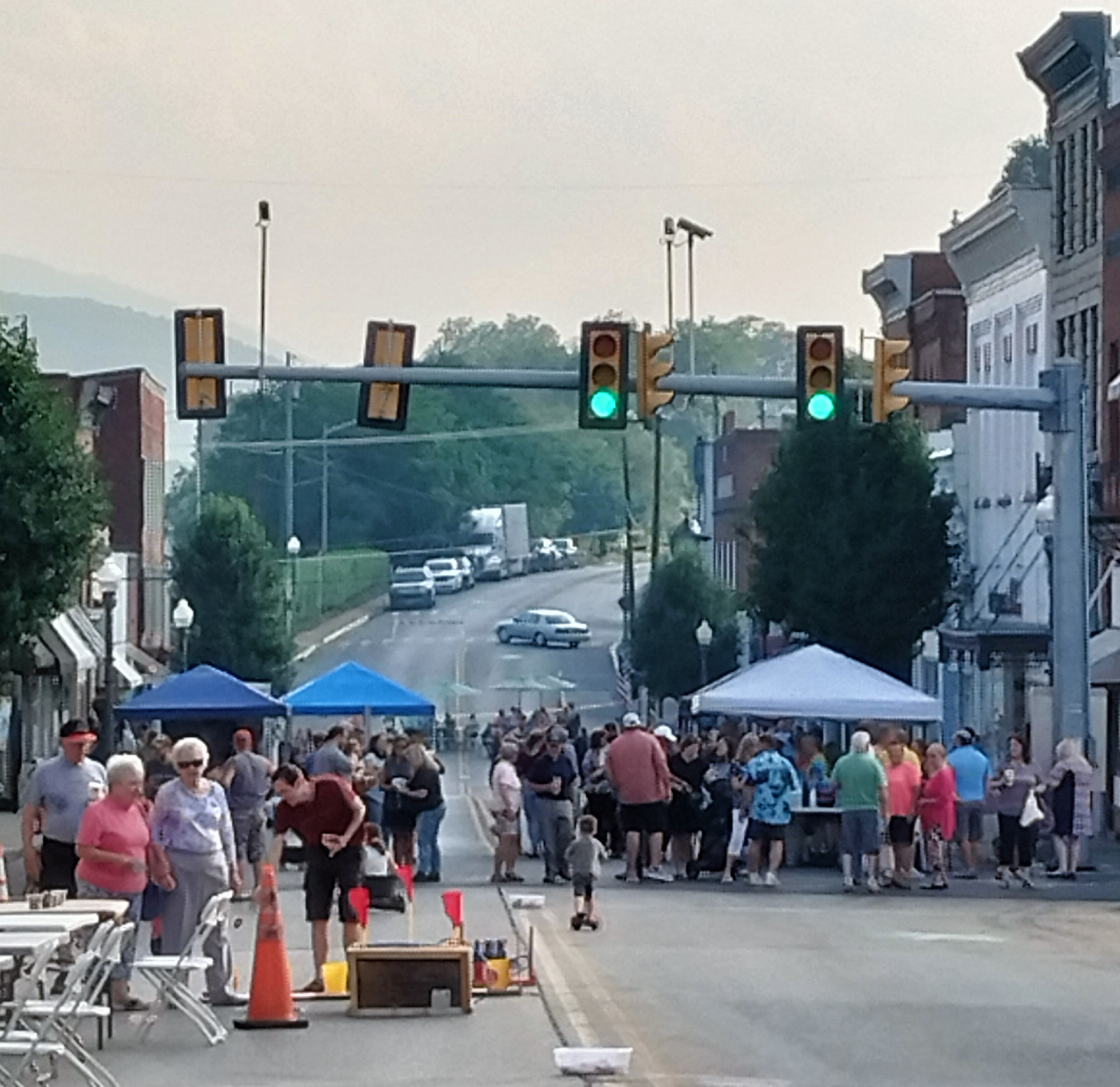 A large crowd gathered on Main Street in Clifton Forge to enjoy the music of local band, "Alibi" playing nearby, vendors, games, sidewalk chalk, and adult refreshments. (Photo by Jennifer Bailey)